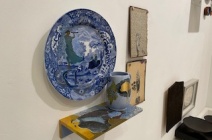 (Clockwise) Charlotte Hodes "Women in conversation, telescopic view" (plate, jug and painting), Monica Fierro "La Vacuna II" (The Vaccine) and "untitled" (shell)